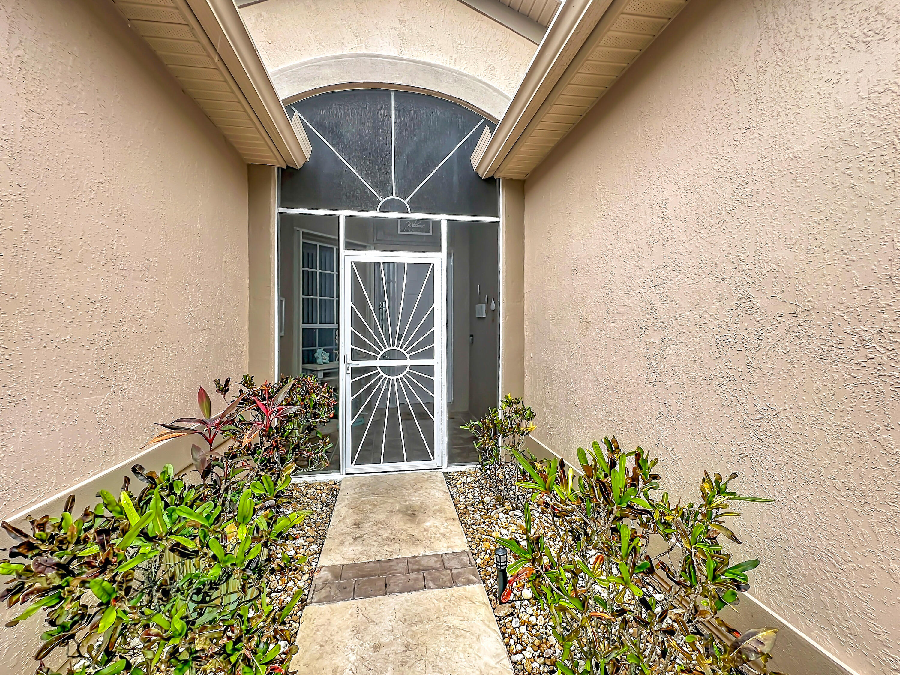 1343 Shoreline Circle Sebastian, FL 32958 - Photo 5 of 36 a potted plant sitting in front of a door