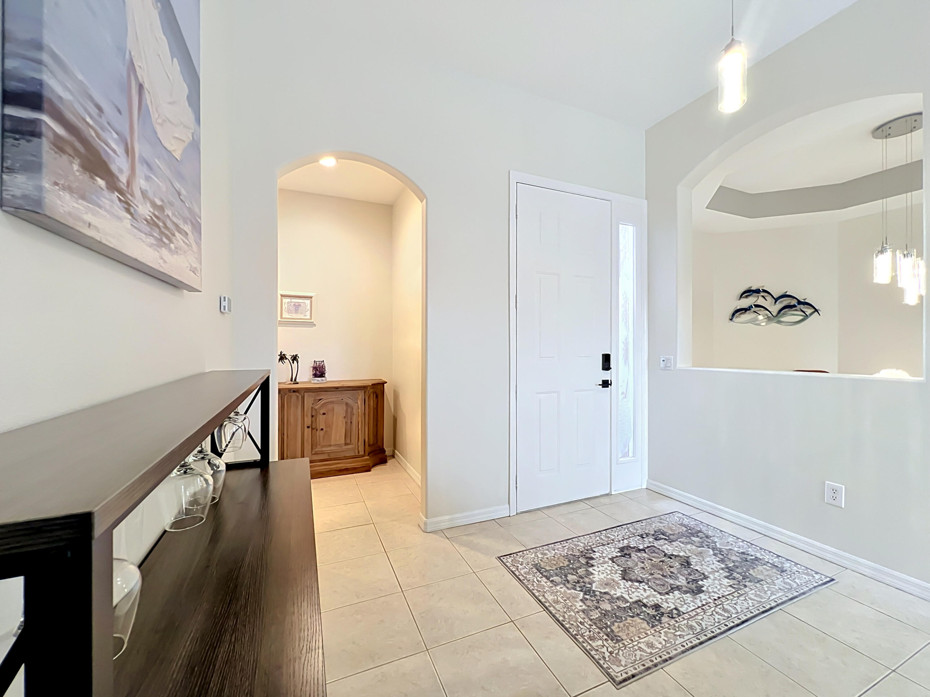 1343 Shoreline Circle Sebastian, FL 32958 - Photo 8 of 36 a view of a hallway to a livingroom with wooden floor and furniture