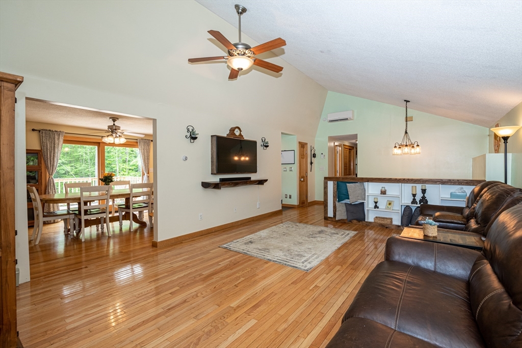 226 Raymond Road Nottingham, NH 03290 - Photo 27 of 42 a living room with furniture and a flat screen tv