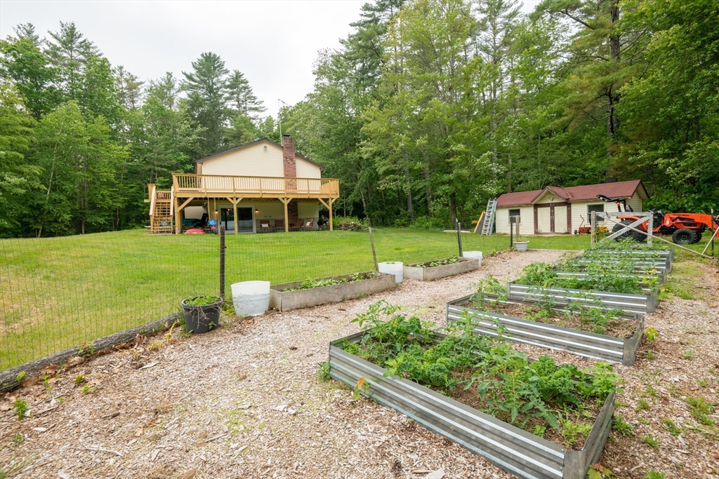 226 Raymond Road Nottingham, NH 03290 - Photo 7 of 42 a view of a house with a yard and sitting area