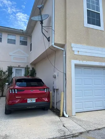 a view of garage with a car parked in it