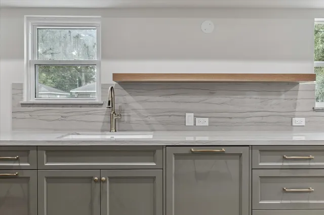 a close view of a stove a mirror and a window