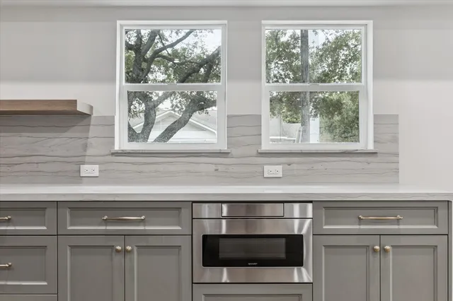 a large kitchen with stainless steel appliances granite countertop a stove and a sink