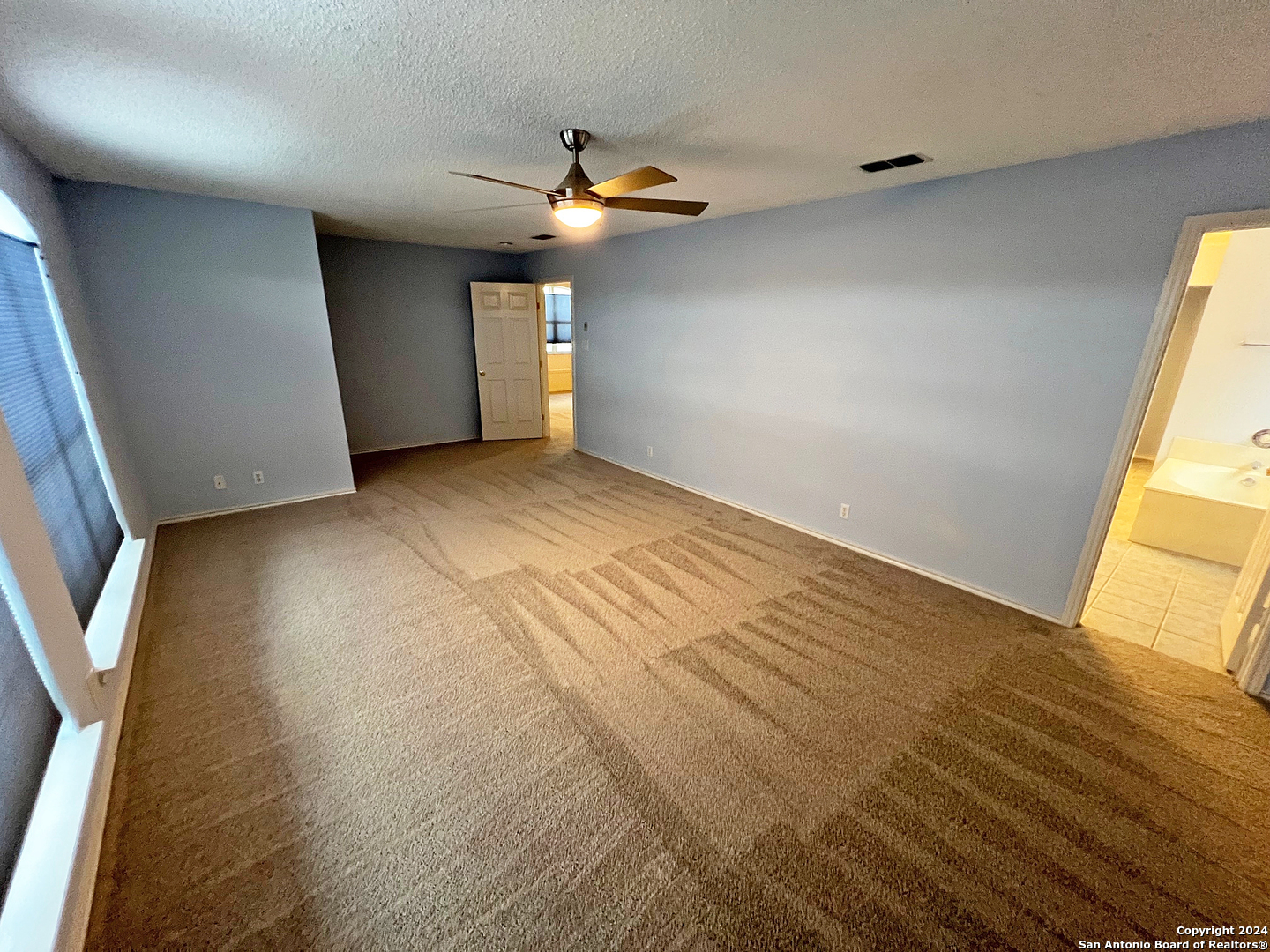 7514 Autumn Ledge Converse, TX 78109 - Photo 14 of 37 an empty room with wooden floor and windows