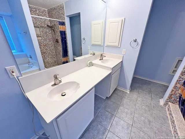 a bathroom with a sink and mirror
