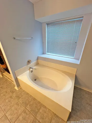 a bathroom with a shower curtain and a sink