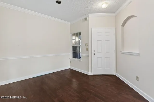 an empty room with wooden floor