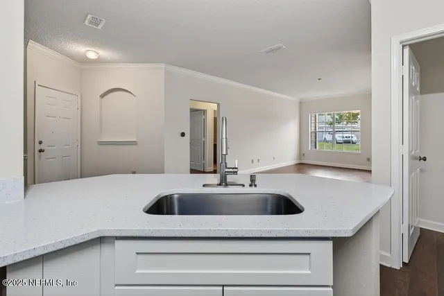 a kitchen with a sink and a refrigerator
