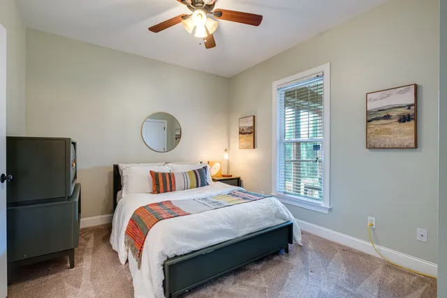 a bedroom with bed and a window