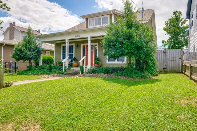 a view of a house with a yard and plants