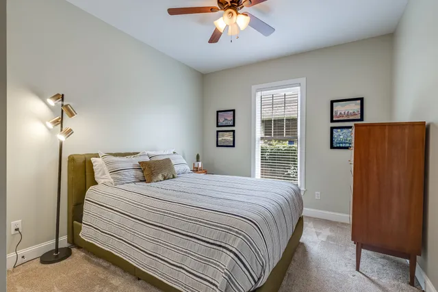 a bedroom with a large bed and a chandelier