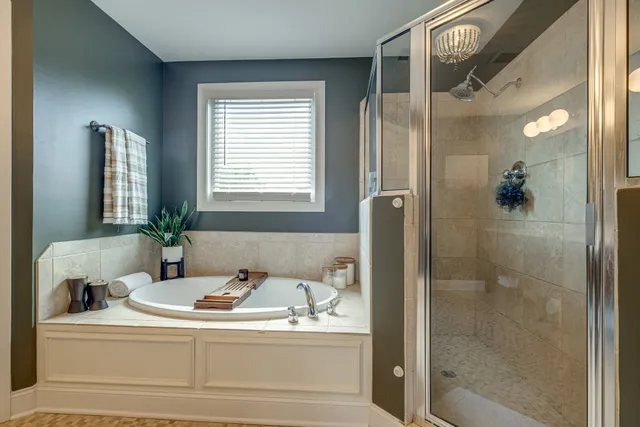 a bathroom with a bathtub and a shower