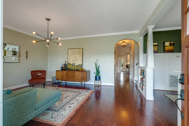a living room with furniture and a chandelier