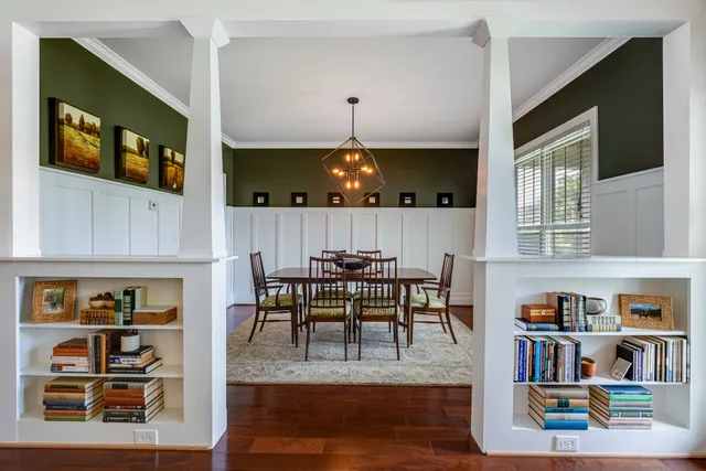 a view of a dining room with furniture and a book shelf