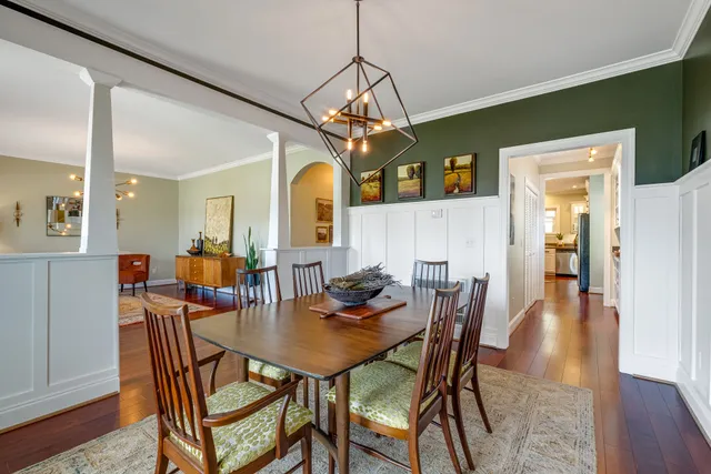a view of a dining room with furniture and wooden floor