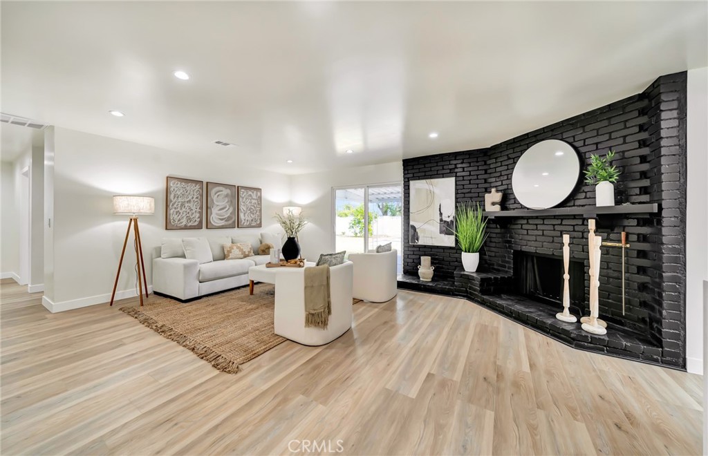6512 Franrivers Avenue West Hills, CA 91307 - Photo 15 of 33 a living room with fireplace furniture and a wooden floor