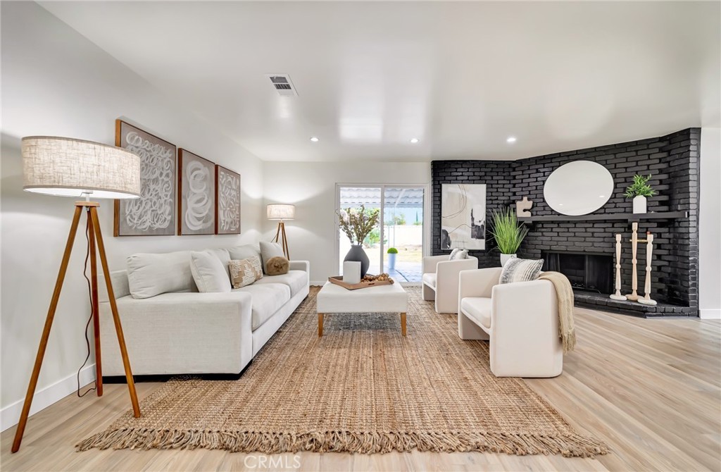 6512 Franrivers Avenue West Hills, CA 91307 - Photo 16 of 33 a living room with furniture a fireplace and a large mirror