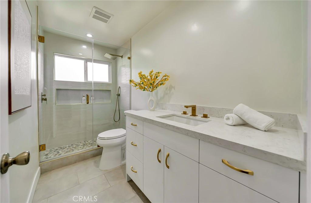 6512 Franrivers Avenue West Hills, CA 91307 - Photo 23 of 33 a bathroom with a granite countertop sink a toilet and a shower