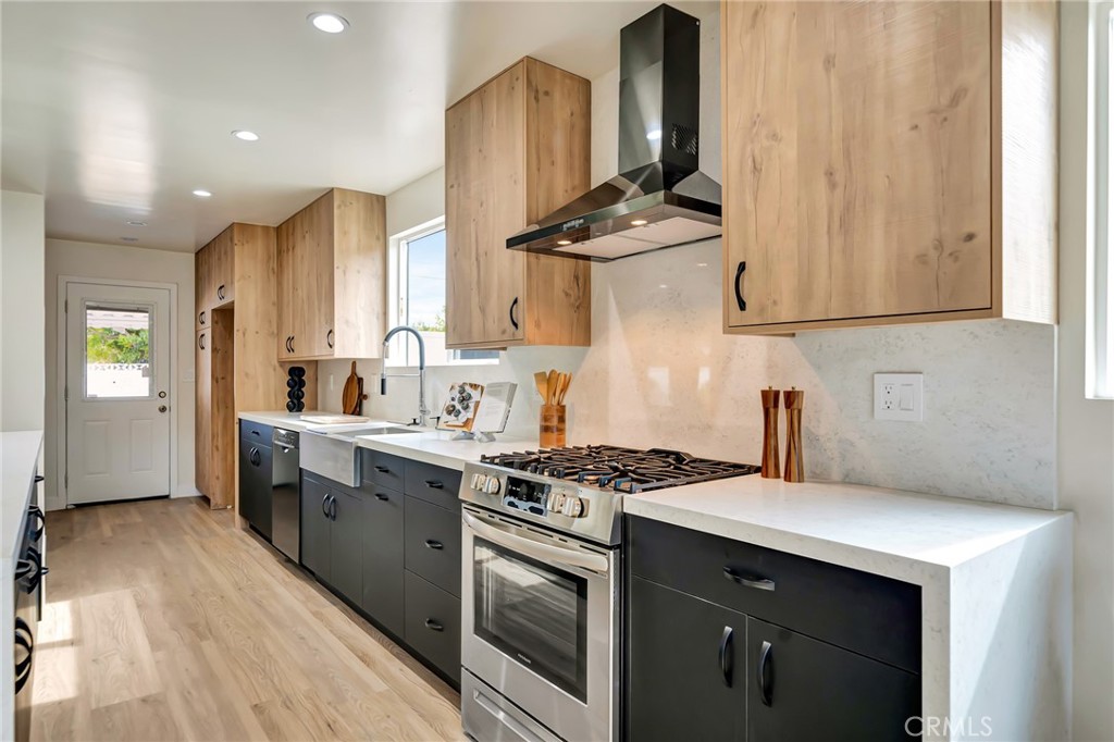 6512 Franrivers Avenue West Hills, CA 91307 - Photo 6 of 33 a kitchen with stainless steel appliances a stove a sink and a refrigerator with wooden floor