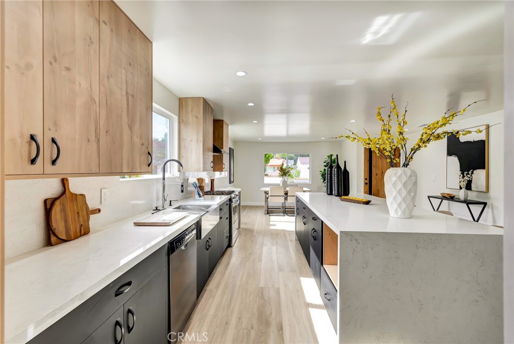 6512 Franrivers Avenue West Hills, CA 91307 - Photo 7 of 33 a large kitchen with granite countertop a sink and a stove top oven