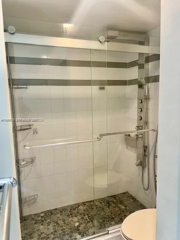 a bathroom with a toilet and a shower