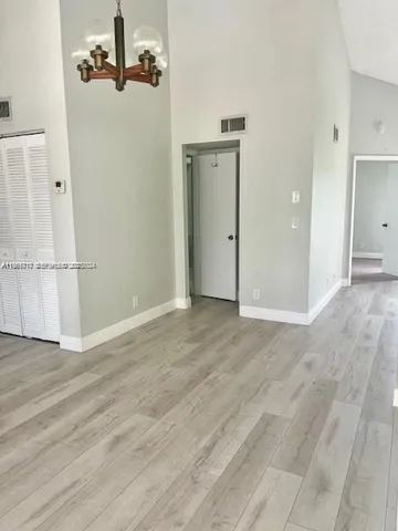 a view of a room with wooden floor and bathroom