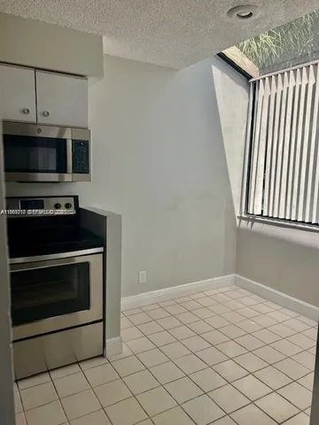 a kitchen with a stove and a microwave