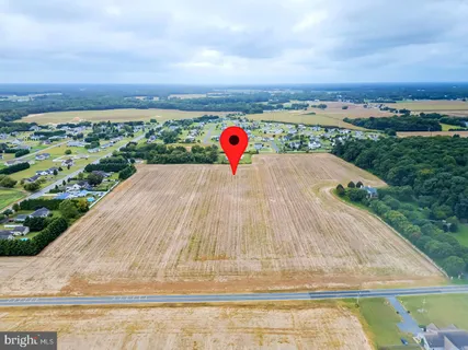 an aerial view of a house with a garden and lake view