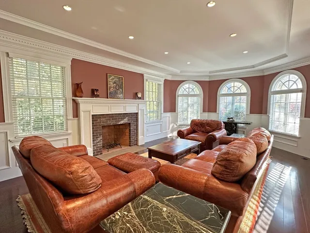 a living room with furniture a large window and a fireplace