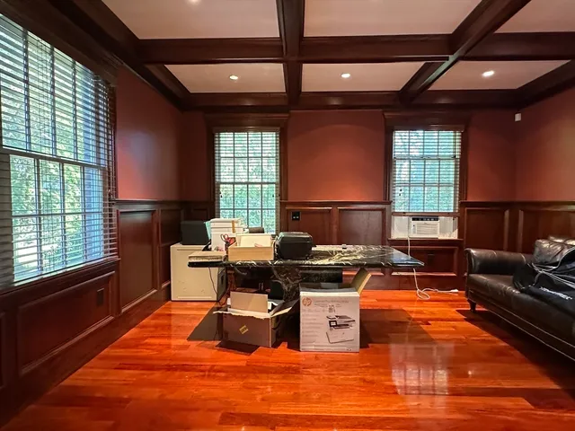 a living room with furniture a wooden floor and a window