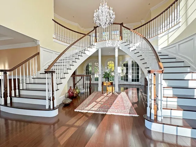 a view of entryway livingroom and hall with wooden floor