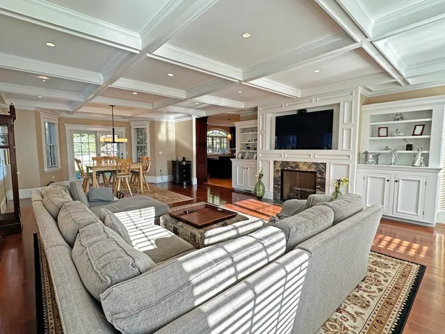 a living room with fireplace furniture and a flat screen tv