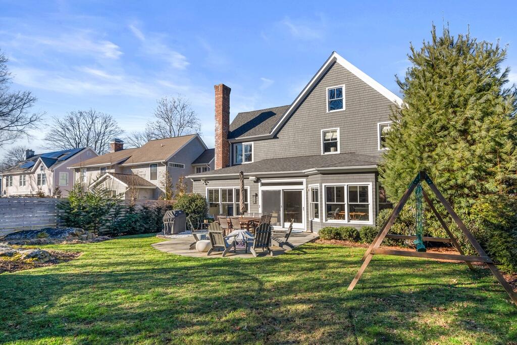 12 1/2 Ridgewood Road Rowayton, CT 06853 - Photo 19 of 25 a front view of a house with a yard table and chairs