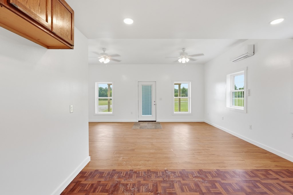 1834 Cummins Mill Road Cookeville, TN 38501 - Photo 10 of 21 an empty room with wooden floor and windows