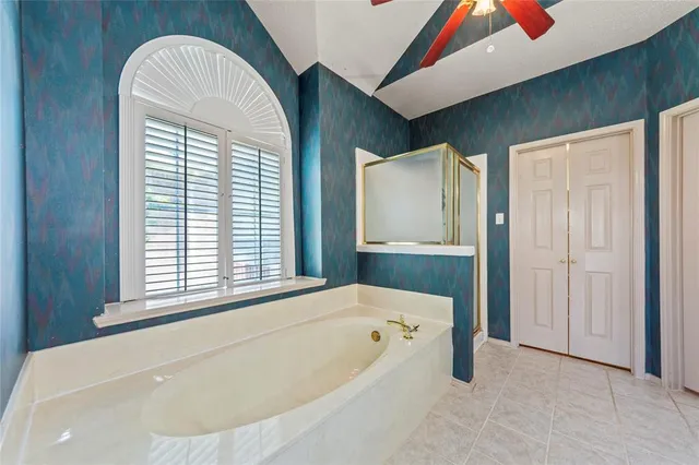 a bathroom with a bathtub and a window