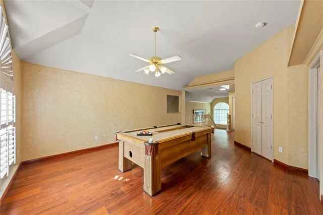 a room with wooden floor and window