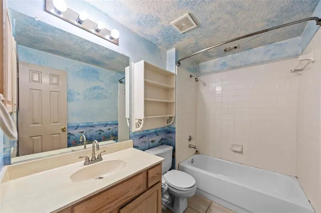 a bathroom with a sink toilet tub and shower