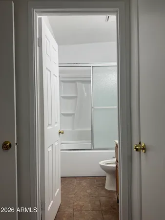a bathroom with a toilet and a shower