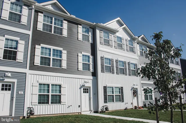 a front view of a building with a garden