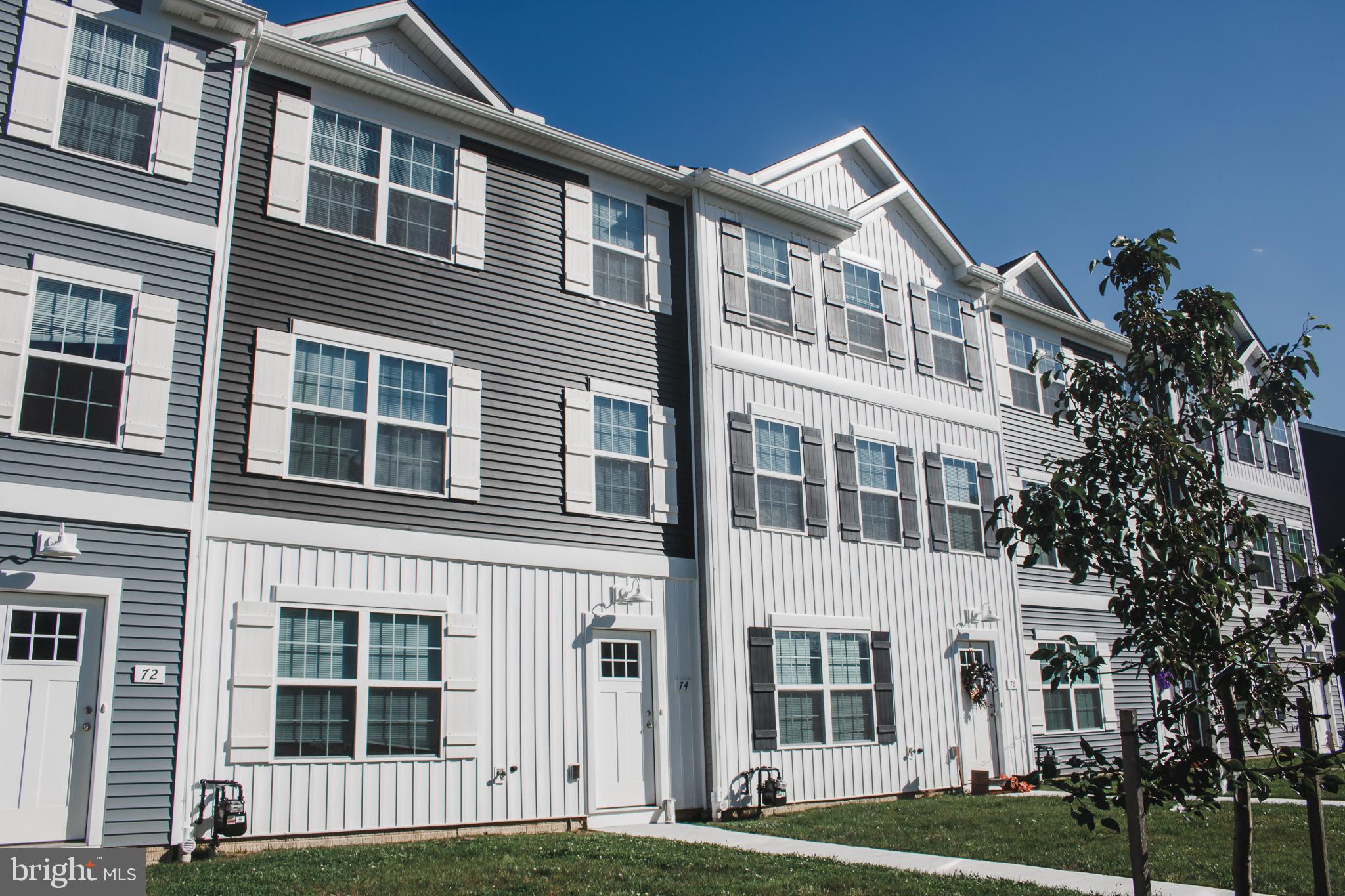 a front view of a building with a garden