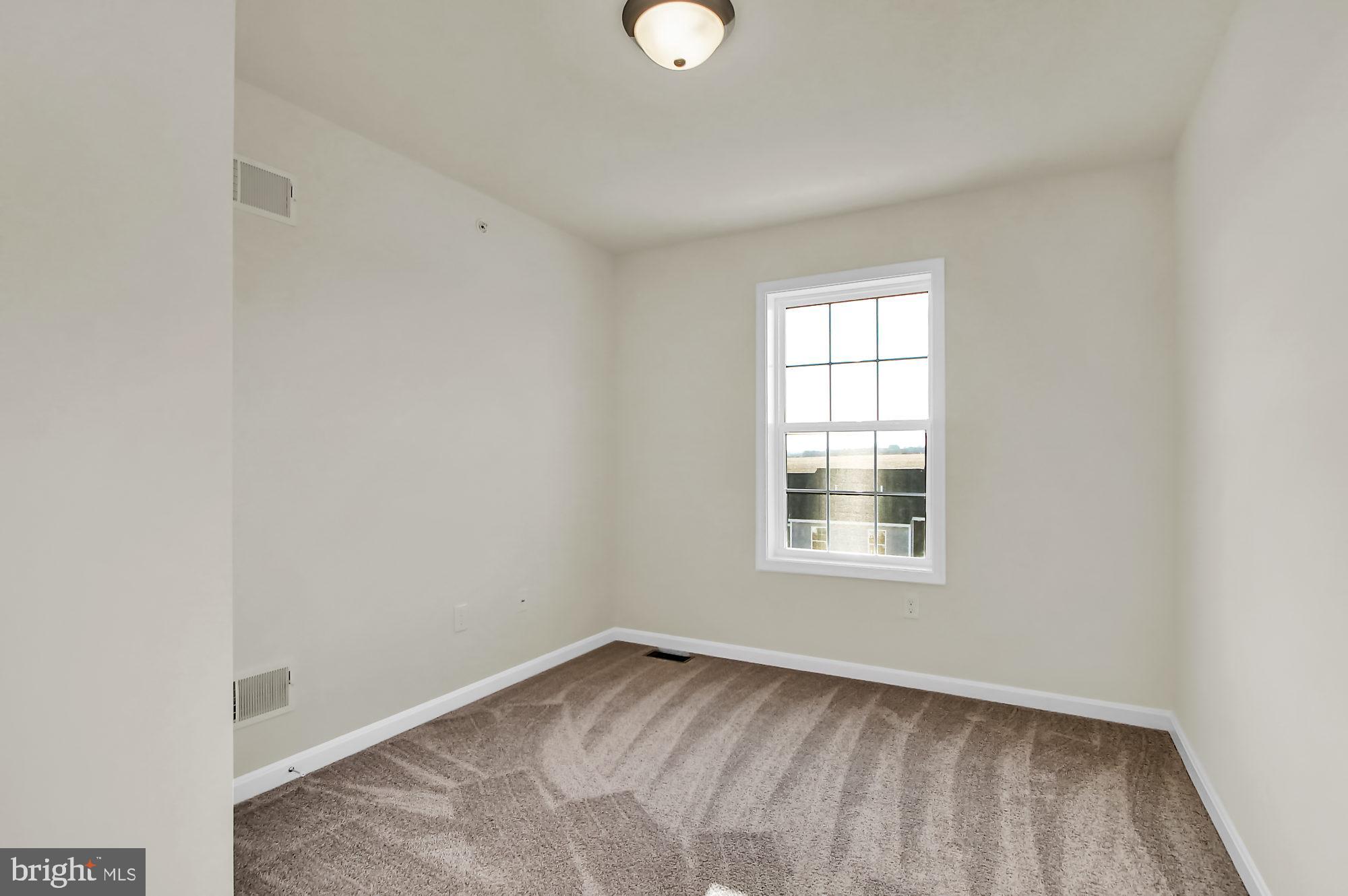 111 Deatrick Drive Gettysburg, PA 17325 - Photo 7 of 9 an empty room with wooden floor and windows