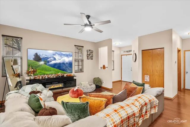 a living room with furniture ceiling fan and a window