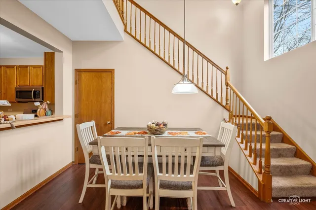 a kitchen with granite countertop a sink wooden floor and stainless steel appliances