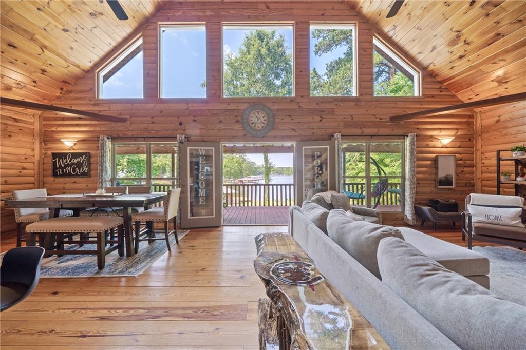 a living room with furniture a fireplace and large windows