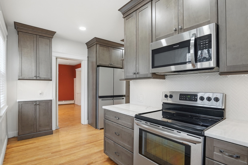7 Columbine Road Worcester, MA 01609 - Photo 12 of 32 a kitchen with stainless steel appliances granite countertop a stove microwave and refrigerator
