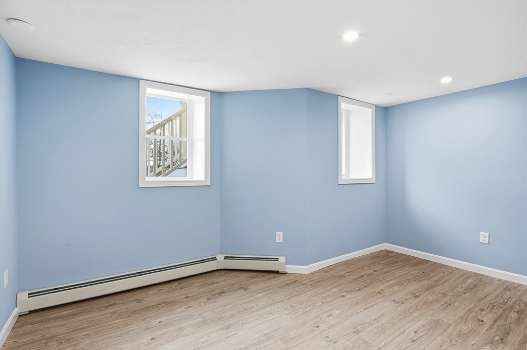 7 Columbine Road Worcester, MA 01609 - Photo 22 of 32 a view of an empty room with wooden floor and a window
