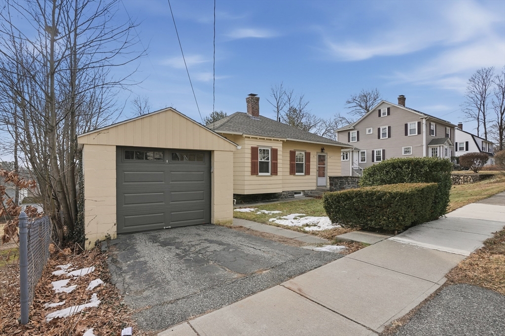 7 Columbine Road Worcester, MA 01609 - Photo 27 of 32 a front view of a house with a yard and garage