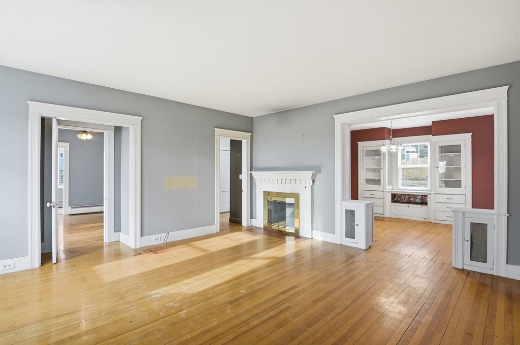 7 Columbine Road Worcester, MA 01609 - Photo 5 of 32 a view of empty room with wooden floor and fireplace