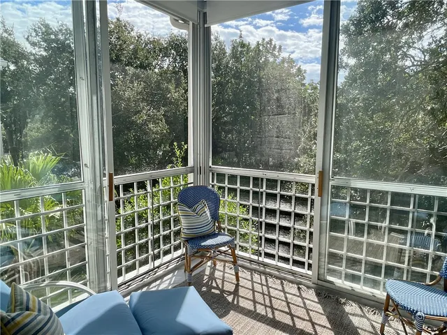 a dining room with furniture and a large window