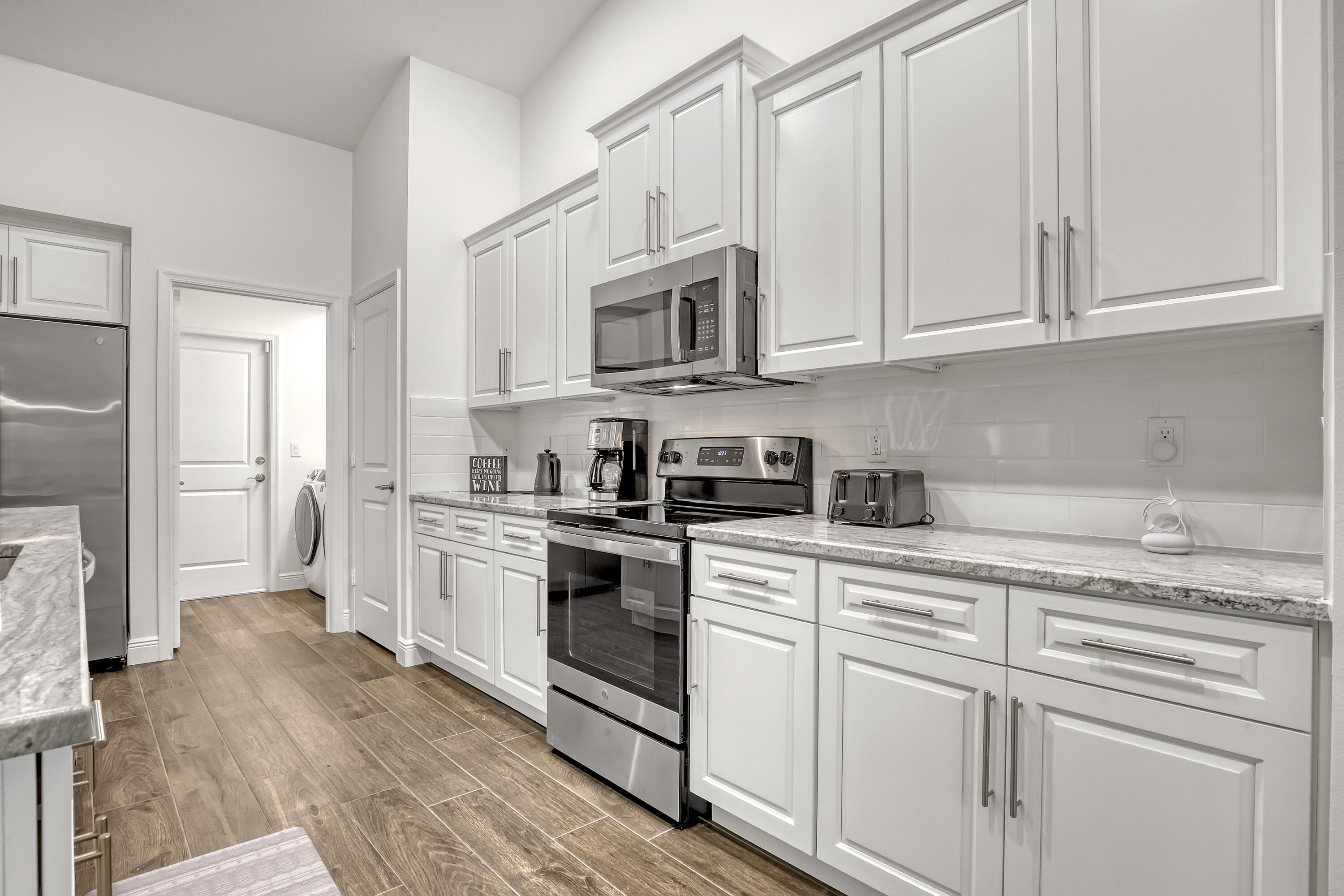 16775 Orange Boulevard Loxahatchee, FL 33470 - Photo 13 of 53 a kitchen with stainless steel appliances granite countertop white cabinets granite counter tops and a hard wood floors